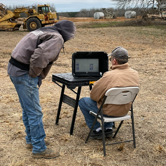 Andrew Vandekop of Well Water Finders showing customer the results of their groundwater survey while on-site
