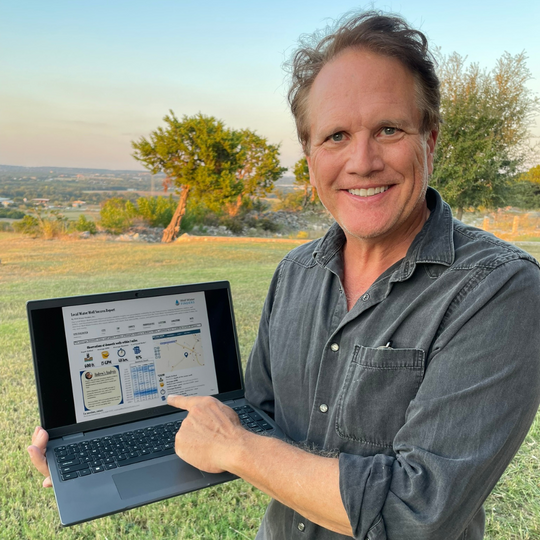 Andrew Vandekop of Well Water Finders showing the Local Water Well Success Report on a laptop, highlighting groundwater depth, flow rates, and well success trends in Texas.