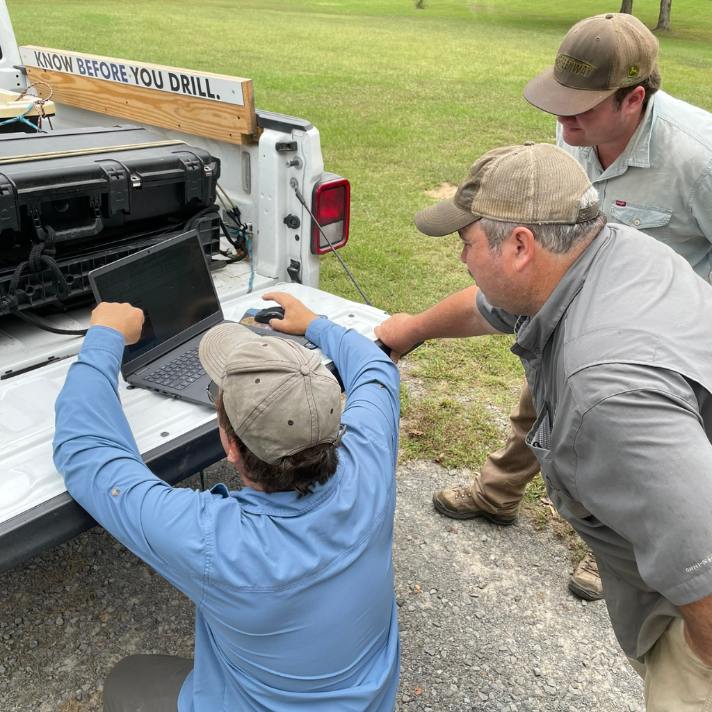 Well Water Finders technician showing customer results of their groundwater survey in near real-time.